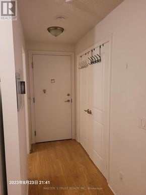 Toronto (Bendale) condo for rent - A hallway with a coat rack and two doors.
