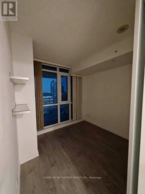 Toronto (Waterfront Communities) condo for rent - A room with a window and a sliding door.