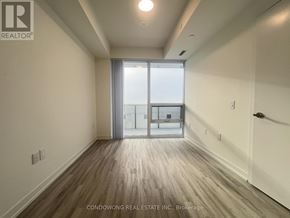 Toronto (Waterfront Communities) condo for rent - A room with a sliding glass door leading to a balcony.