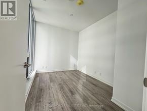 Toronto (Waterfront Communities) condo for rent - A room with wood flooring and white walls.