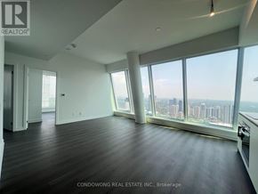 Toronto (Bay Street Corridor) condo for rent - A spacious room with a view of the city skyline.