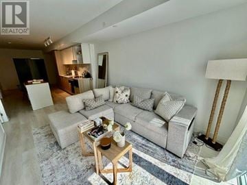 Toronto (Church-Yonge Corridor) condo for rent - A living room with a grey couch and a wooden coffee table.