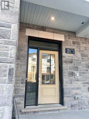 Ottawa townhouse for rent - The door is numbered 207 and is part of a stone building.