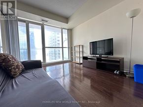 Toronto (Bay Street Corridor) condo for rent - A bedroom with a large bed and a flat screen TV.