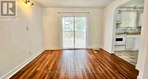 Niagara Falls (Hospital) apartment for rent - A room with wooden flooring and a sliding glass door.