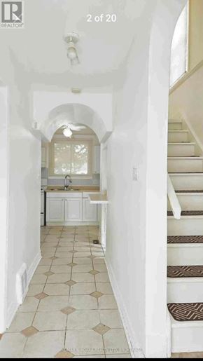 Niagara Falls (Hospital) apartment for rent - A hallway with a staircase and a kitchen area.
