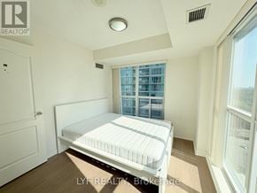 Toronto (Bendale) condo for rent - A bedroom with a bed, a window, and a door.