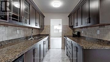 Toronto (Black Creek) condo for rent - A kitchen with dark brown cabinets and granite countertops.