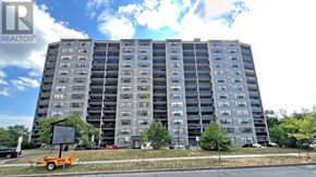 Toronto (Black Creek) condo for rent - A tall residential building with a sign in front that says Home/Mirage Realty.