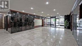 Toronto (Black Creek) condo for rent - A spacious lobby with a marble floor and a glass wall.