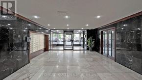Toronto (Black Creek) condo for rent - A hallway with marble floors and walls, and a ceiling with recessed lighting.
