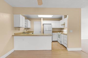 Hayward apartment for rent - A kitchen with white cabinets and appliances.