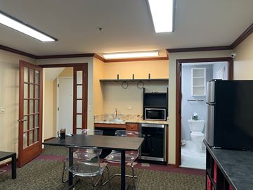 Gurnee apartment for rent - A kitchen with a table and chairs in the foreground and a refrigerator in the background.