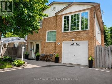 Oshawa (Vanier) apartment for rent - A house with a white garage door and a brick exterior is for sale.