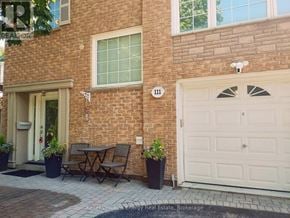 Oshawa (Vanier) apartment for rent - A brick house with a white garage door and a number 111 on the wall.