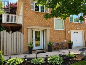 Oshawa (Vanier) apartment for rent - A house with a patio and a white door.