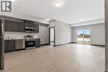 Mount Forest apartment for rent - A spacious kitchen with dark brown cabinets and stainless steel appliances.