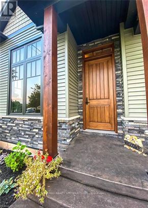 Fort Erie (Crystal Beach) apartment for rent - A house with a wooden door and a flower pot on the steps.