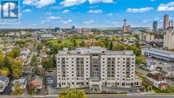 Niagara Falls (Hospital) condo for rent - A large building with the words RE/MAX Realty Specialists Inc. Brokerage in front of it.