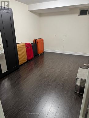 Brampton (Bram West) apartment for rent - A room with a black filing cabinet and four suitcases of different colors.