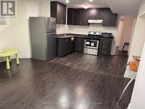 Brampton (Bram West) apartment for rent - A kitchen with dark wood floors and modern appliances.