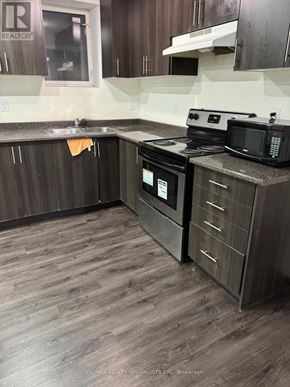 Brampton (Bram West) apartment for rent - A kitchen with a stove and microwave.
