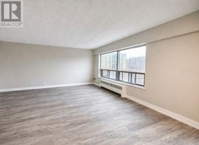Toronto (South Parkdale) condo for rent - A spacious room with a window seat and wooden flooring.