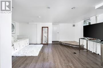 Toronto (Oakwood Village) apartment for rent - A spacious living room with a white rug and a wooden floor.