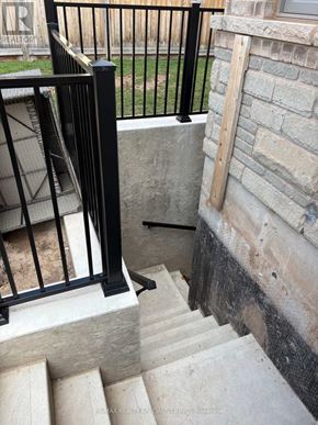 Oakville (Ga Glen Abbey) apartment for rent - A set of stairs with a black railing and a stone wall.