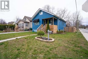 Niagara Falls (Downtown) apartment for rent - A blue house with a sign in front of it.