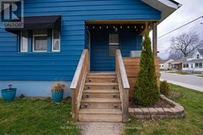 Niagara Falls (Downtown) apartment for rent - A blue house with a wooden staircase leading to the front door.