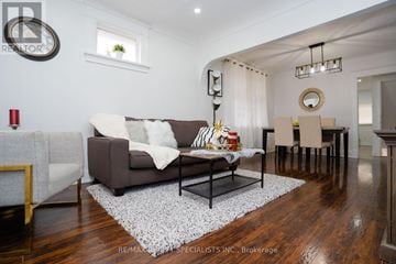 Niagara Falls (Downtown) apartment for rent - A living room with a brown couch and a white rug.