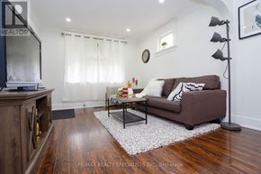 Niagara Falls (Downtown) apartment for rent - A living room with a brown couch and a wooden floor.