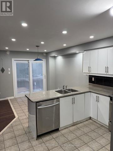 Mississauga (Lisgar) apartment for rent - A modern kitchen with white cabinets and a stainless steel dishwasher.