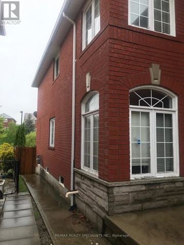 Mississauga (Lisgar) apartment for rent - A red brick building with a large arched window and a small window above it.