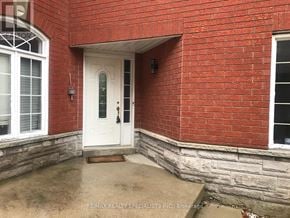 Mississauga (Lisgar) apartment for rent - A red brick house with a white door and windows.