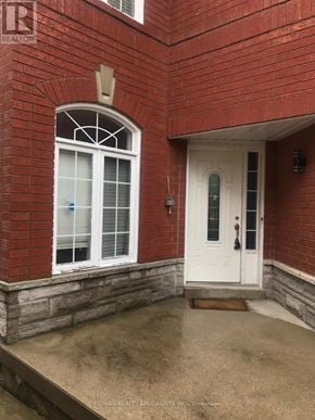 Mississauga (Lisgar) apartment for rent - A red brick house with a white door and window.