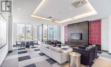 Mississauga (City Centre) condo for rent - A living room with a grey sofa and a television.