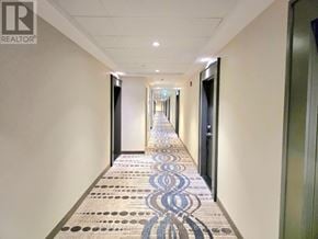 Burlington (Tansley) condo for rent - A hallway with a patterned tile floor and doors on both sides.