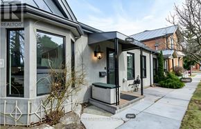 Hamilton (Corktown) apartment for rent - A modern house with a grey roof and a glass door.