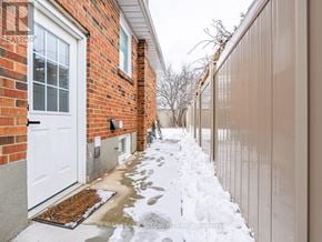Toronto (Humber Heights) apartment for rent - A snowy sidewalk leads to a white door.