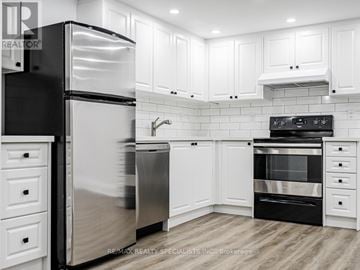 Toronto (Humber Heights) apartment for rent - A modern kitchen with white cabinets and stainless steel appliances.