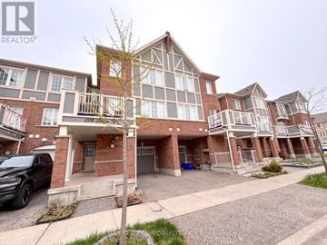 Milton (Fo Ford) townhouse for rent - A large brick building with a tree in front of it.