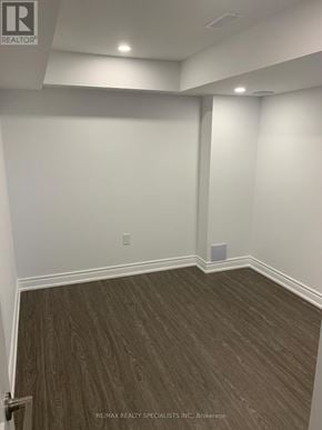 Vaughan (Kleinburg) apartment for rent - A room with wooden flooring and white walls.