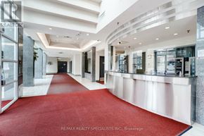 Mississauga (City Centre) condo for rent - A hallway with a red carpet and white walls.