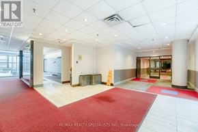 Mississauga (City Centre) condo for rent - A hallway with a red carpet and white walls.