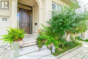 Richmond Hill (South Richvale) apartment for rent - A house entrance with a brown door and a plant in a vase.