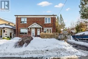 Toronto (Briar Hill-Belgravia) apartment for rent - A house with a snow-covered front yard.