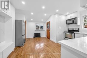 Toronto (Briar Hill-Belgravia) apartment for rent - A kitchen with a refrigerator, microwave, oven, and a counter.