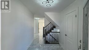 Kitchener apartment for rent - A hallway with a staircase and a white door.